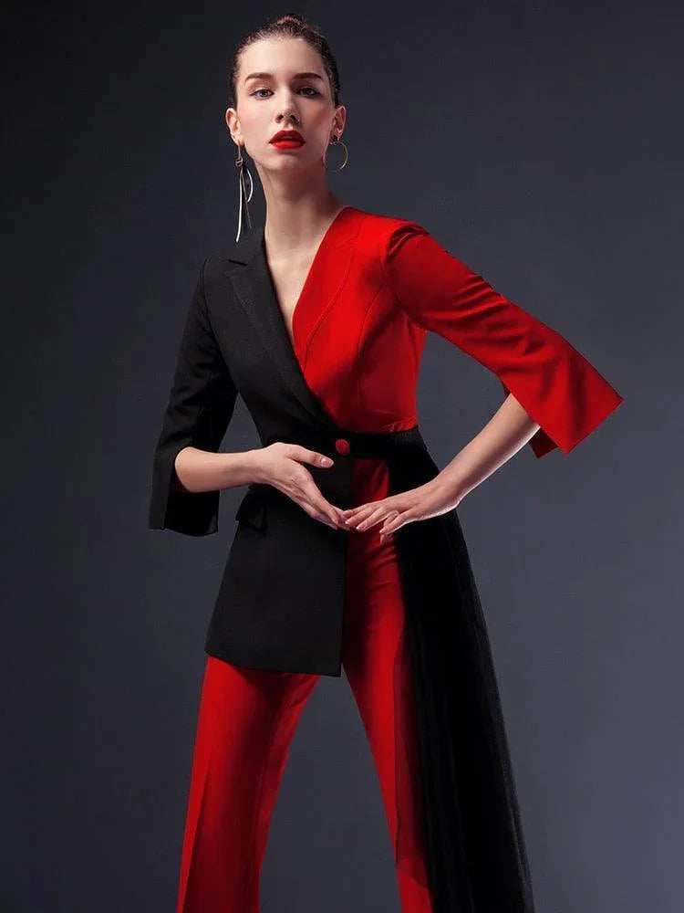 Woman in a red and black pantsuit with detachable veil, fashion studio shot