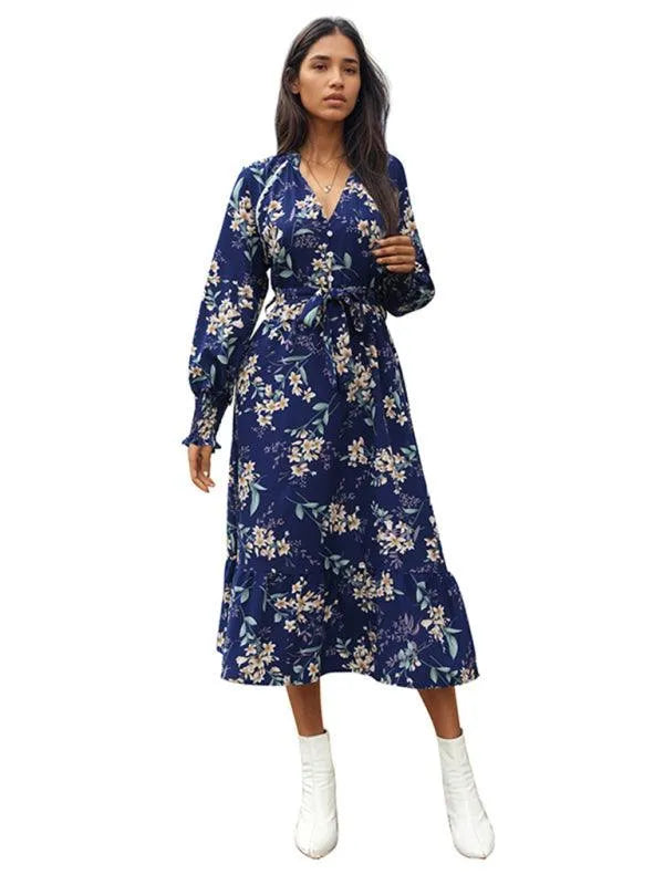 Woman in a navy floral long-sleeve wrap midi dress with white boots fashion image